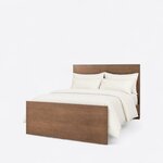 Diagonal angled view showing the left side of a modern panel bed, with a tall slab headboard and a lower slab footboard.