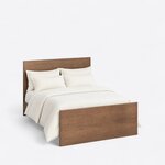 High angled view of a modern panel bed, looking down on the flat slab headboard and footboard with square corners.
