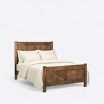 Diagonal angled view showing the right side of a rustic panel bed, with a barn-door braced headboard and footboard.