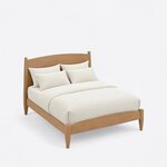 High angled view of a modern panel bed, looking down on the arched headboard, plain side rails and low arched footboard.