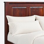 Headboard close-up of a traditional storage bed, showing beveled framed panels, a square post and a rounded cap rail.