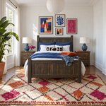 Front room view of a farmhouse panel bed with a two-panel headboard and footboard, in a white bedroom with gallery art.