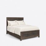Diagonal angled view showing the right side of a rustic panel bed, with a framed panel headboard and low panel footboard.