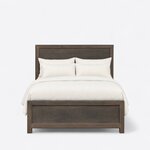 Front view of a rustic panel bed, showing a tall single-panel headboard and a low single-panel footboard on block legs.