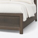 Footboard close-up of a rustic panel bed, showing a recessed panel set in a wide flat frame above a square block leg.