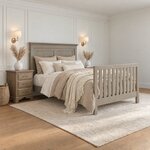 Diagonal angled room view showing the right side of a transitional panel bed with a slatted footboard, in a paneled bedroom.