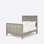 Diagonal angled view showing the left side of a transitional panel bed, with a crown-molded headboard and slatted footboard.