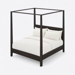 High angled view of a modern canopy bed, looking down on the open canopy frame, square posts and low panel headboard.