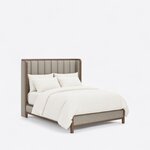 Diagonal angled view showing the right side of a modern upholstered bed, with a tall channel-tufted wingback headboard.
