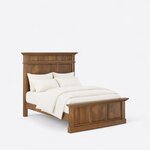 Diagonal angled view showing the right side of a traditional panel bed, with a crowned three-panel headboard and footboard.