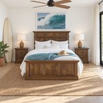 Front room view of a traditional panel bed with a three-panel footboard, in a white beach house bedroom with a ceiling fan.