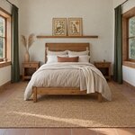 Front room view of a transitional sleigh bed with a rolled panel headboard, in a plaster bedroom with terracotta tiles.