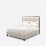 Diagonal angled view showing the left side of a modern upholstered bed, with a framed panel headboard and tapered feet.