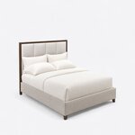 High angled view of a modern upholstered bed, looking down on the grid-paneled headboard and fully upholstered base.