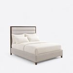 Diagonal angled view showing the right side of a modern upholstered bed, with a framed, horizontally channeled headboard.