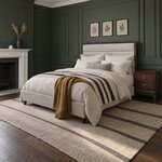 Diagonal angled room view showing the left side of a modern upholstered bed with channel tufting, in a green-paneled room.