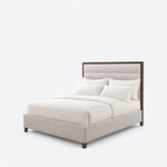 Diagonal angled view showing the left side of a modern upholstered bed, with a framed, horizontally channeled headboard.