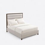 High angled view of a modern upholstered bed, looking down on the channeled headboard, upholstered rails and low footboard.