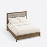High angled view of a contemporary upholstered bed, looking down on the tufted headboard, molded rails and tapered legs.