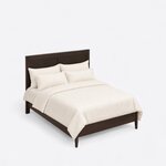 High angled view of a minimalist panel bed, looking down on the flat-topped headboard, plain side rails and tapered legs.