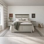 Front room view of a coastal panel bed with a louvered headboard and bun feet, in a whitewashed log cabin bedroom.