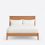 Front view of a mid-century panel bed, showing a broad flat-panel headboard, a low footboard and tapered square legs.