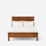 Front view of a transitional panel bed, showing a tall capped plank headboard and a low capped footboard on square legs.