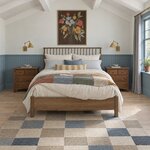Front room view of a Windsor spindle bed with a spindle headboard, in a bedroom with blue beadboard wainscoting.
