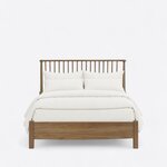 Front view of a Windsor spindle bed, showing a wide spindle headboard and a low footboard with a gently bowed lower edge.