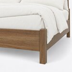 Footboard close-up of a Windsor spindle bed, showing a square corner post and leg beside the plain footboard and side rail.