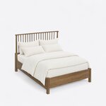 High angled view of a Windsor spindle bed, looking down on the side rails, square legs and low solid footboard.