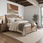 Diagonal angled room view showing the right side of a traditional panel bed with an arched headboard, in a beamed bedroom.