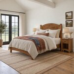 Diagonal angled room view showing the left side of a transitional panel bed with a low footboard, in a vaulted bedroom.