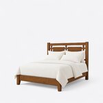 Diagonal angled view showing the left side of a farmhouse panel bed, with an open-panel headboard and tapered foot legs.