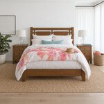 Front room view of a farmhouse panel bed with an open-panel headboard, in a white bedroom with sheer curtains.