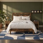 Front room view of a farmhouse panel bed with an open-panel headboard and low footboard, in an olive-green bedroom.