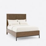 Diagonal angled view showing the right side of a modern panel bed, with a two-panel headboard and a metal base at the foot.