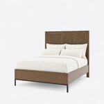 Diagonal angled view showing the left side of a modern panel bed, with a two-panel headboard and a metal base at the foot.