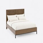 High angled view of a modern panel bed, looking down on the deep side rails and the low footboard on a slim metal base.