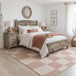 Diagonal angled room view showing the right side of a rustic panel bed with an arched headboard, in a white coastal bedroom.