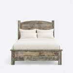 Front view of a rustic panel bed, showing an arched plank headboard between square posts and a low plank footboard.