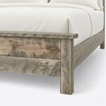 Footboard close-up of a rustic panel bed, showing the overhanging cap rail, a square corner leg and horizontal planks.