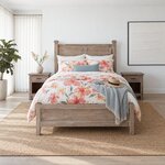 Front room view of a farmhouse panel bed with capped head posts, in a white coastal bedroom with sheer curtains.
