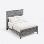 High angled view of a farmhouse panel bed, looking down on the capped louvered headboard, side rails and panel footboard.