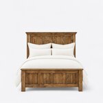 Front view of a Craftsman panel bed, showing a tall headboard with a crown-molded cap above a low four-panel footboard.