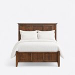 Front view of a Shaker panel bed, showing a tall corniced three-panel headboard above a lower three-panel footboard.