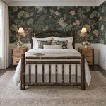 Front room view of a rustic log bed with an arched sunburst headboard, in a bedroom with floral wallpaper over wainscoting.