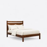 Diagonal angled view showing the right side of a modern panel bed, with an open-slot headboard and a low footboard.
