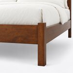 Footboard close-up of a modern panel bed, showing the square corner post, plain foot rail and straight square leg.