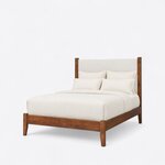 Diagonal angled view showing the left side of a modern upholstered bed, with an upholstered headboard and tapered legs.